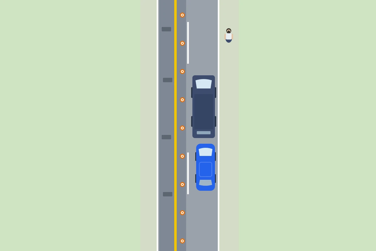 En unas obras, la furgoneta espera la primera y el coche azul espera justo detrás, los dos junto al borde derecho.
