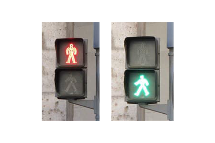 Dos semáforos de peatones: figura roja inmóvil y figura verde en marcha