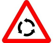 Señal: Glorieta: peligro por la proximidad de una glorieta con circulación en el sentido indicado por las flechas